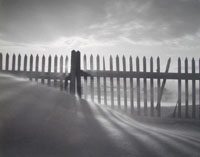FENCE SHADOWS IN SNOW AT SUNRISE